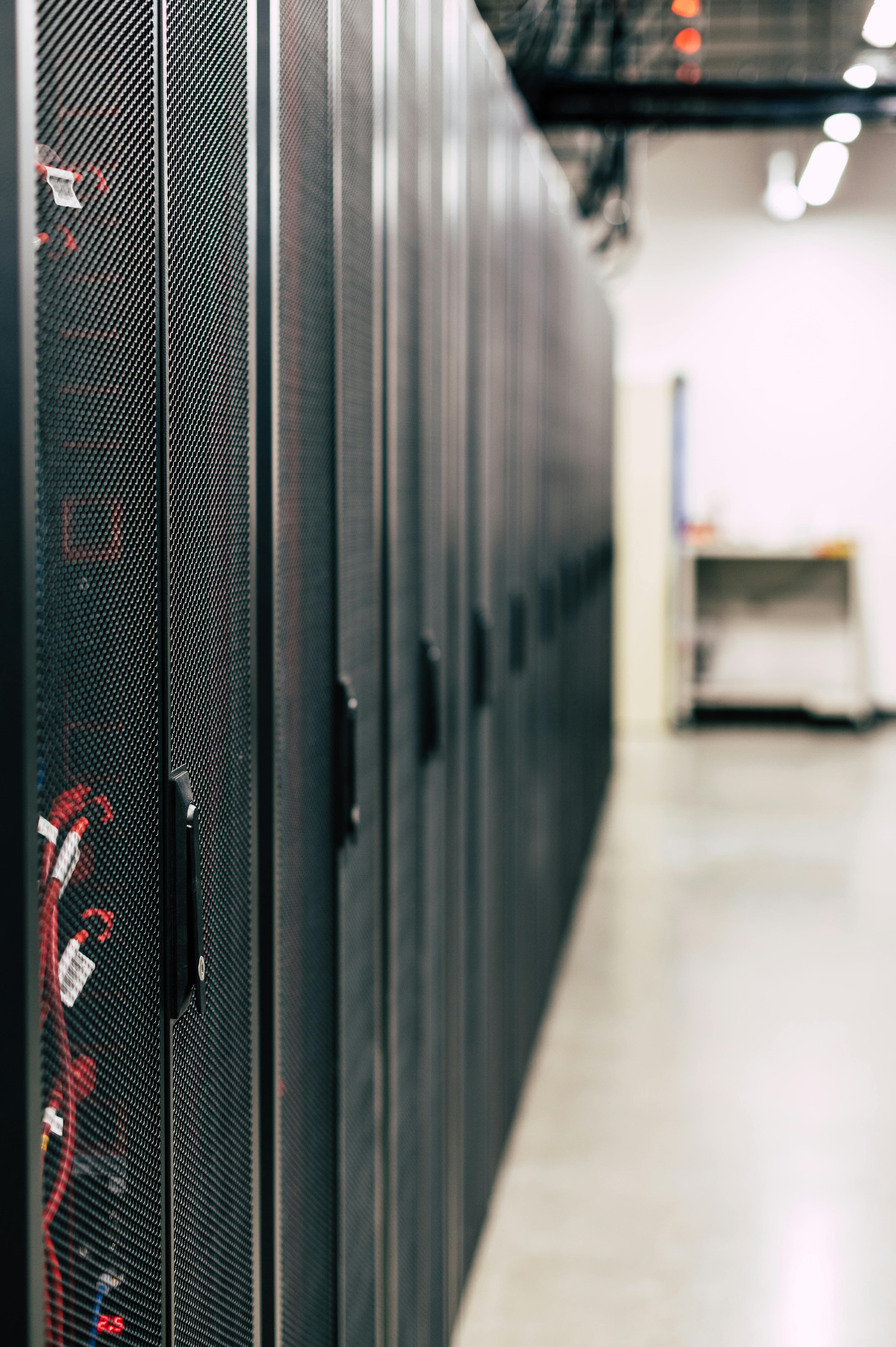 Row of black server racks in a data hall