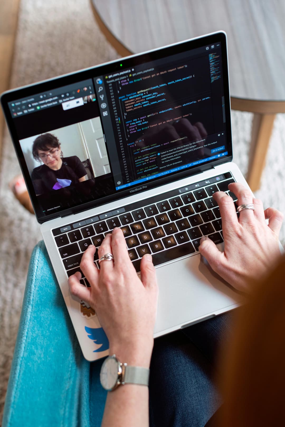 Laptop showing code and a remote meeting for an article about enterprise AI workflows