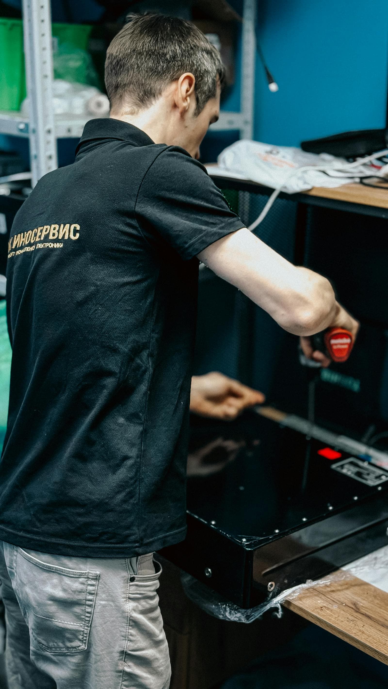 Technician repairing computer equipment at a workbench