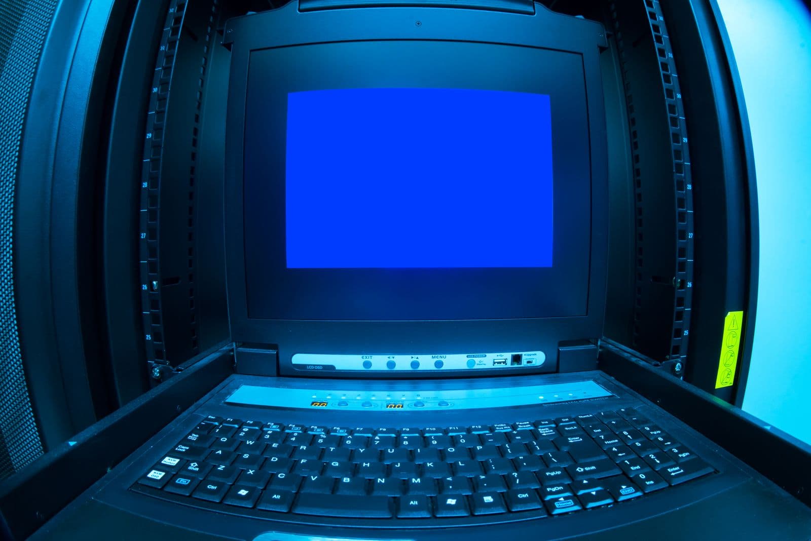 Technisches Terminal neben Serverracks mit einer Fehleranzeige