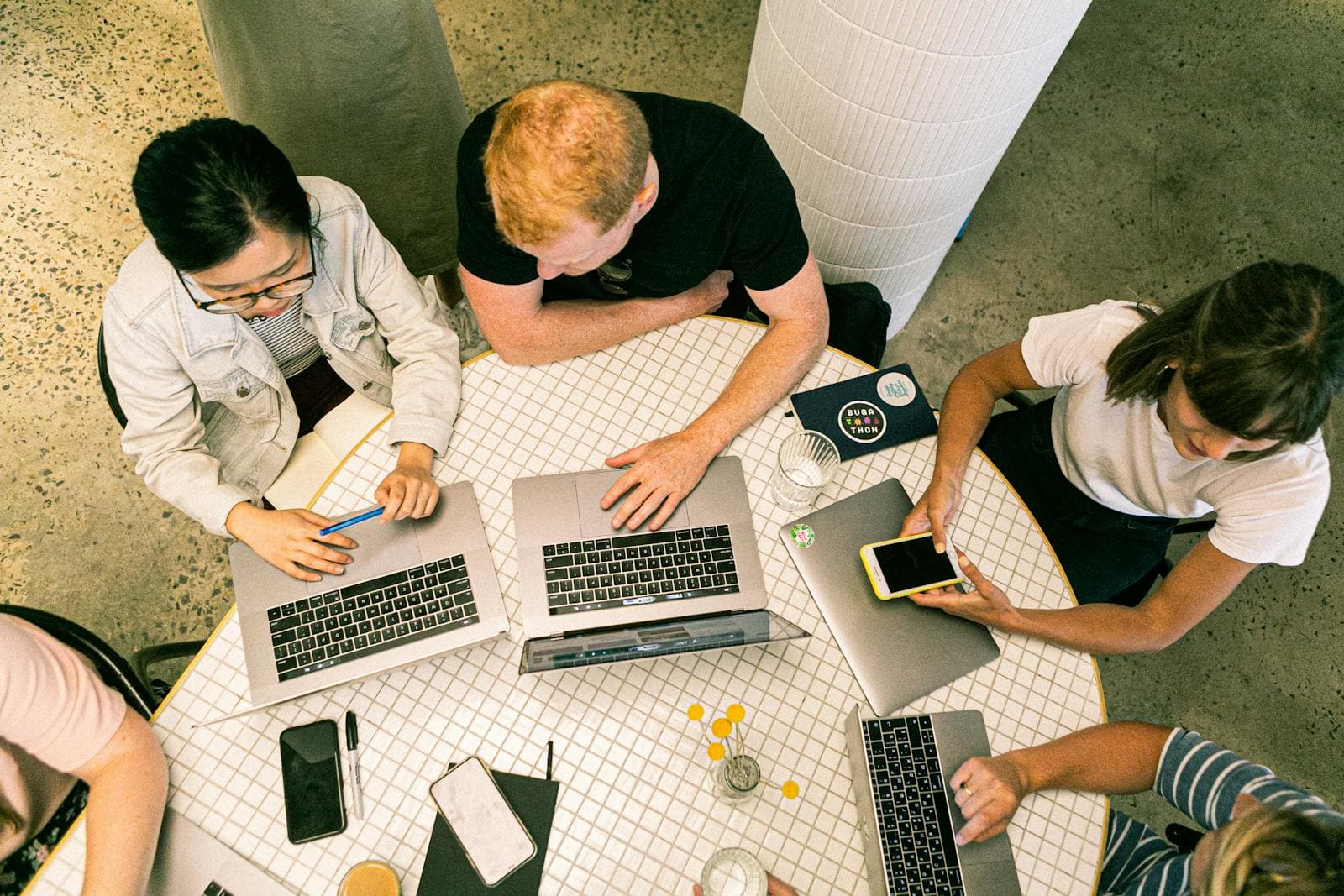 Top view of a team working with laptops and notes during a planning session