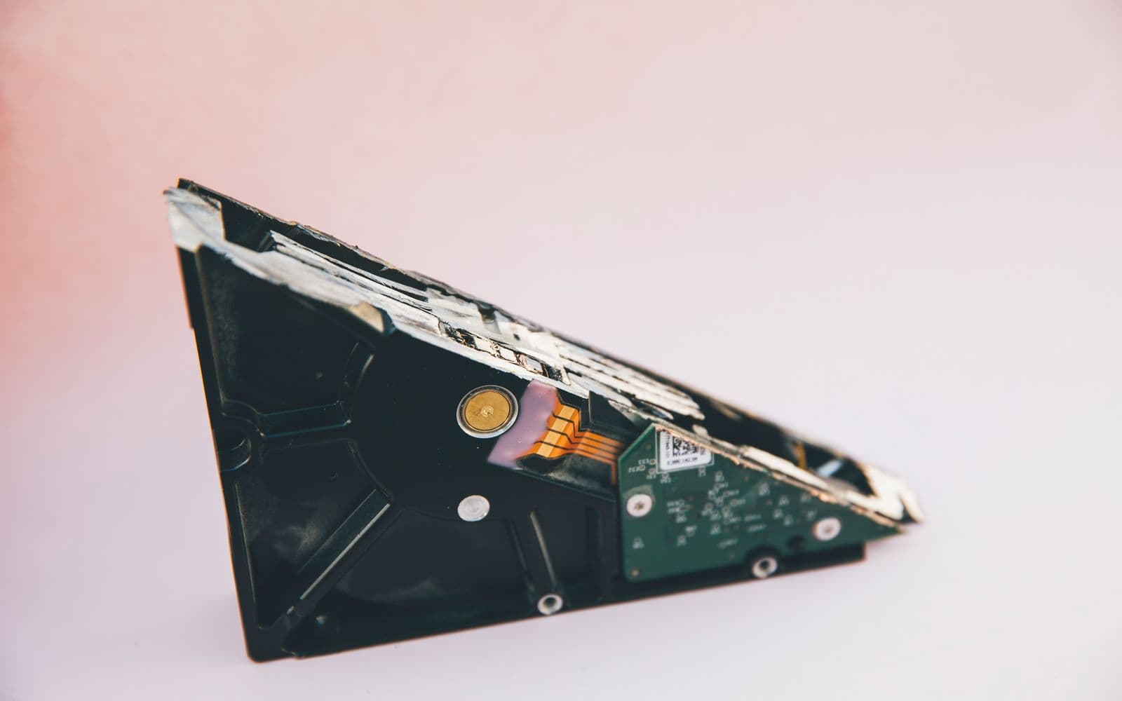 Open hard drive with visible platter and actuator arm