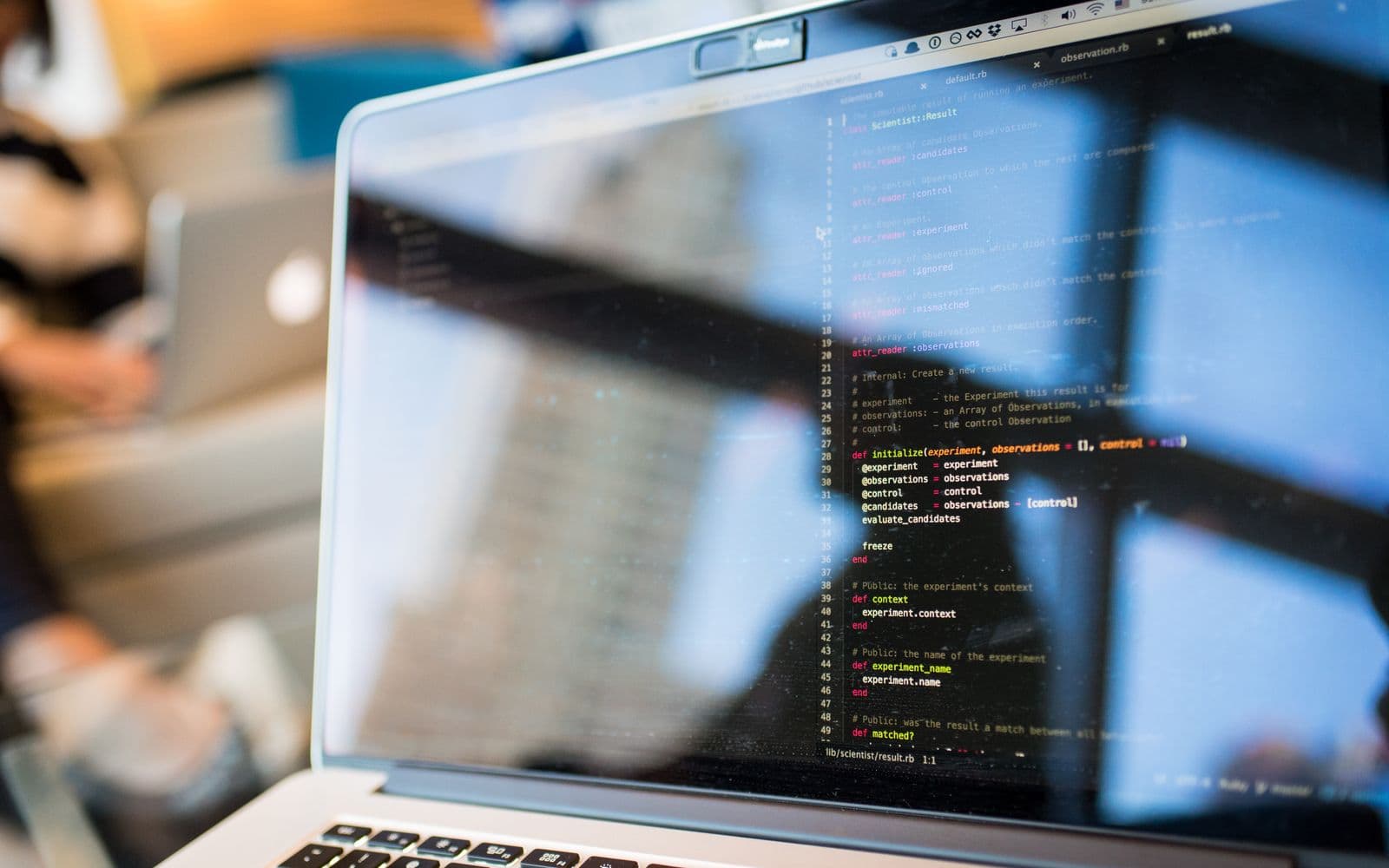 Laptop showing source code in a development workspace